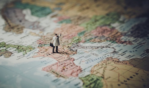 Little Man Figure Standing on Time Zone Map